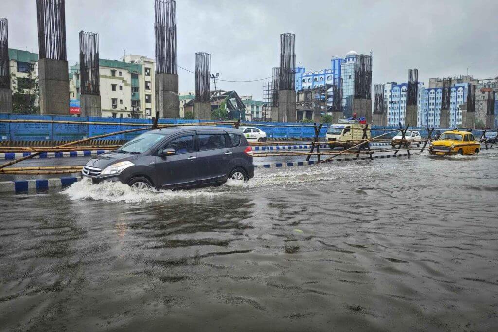 Cars driving through flooded urban road after heavy rainfall