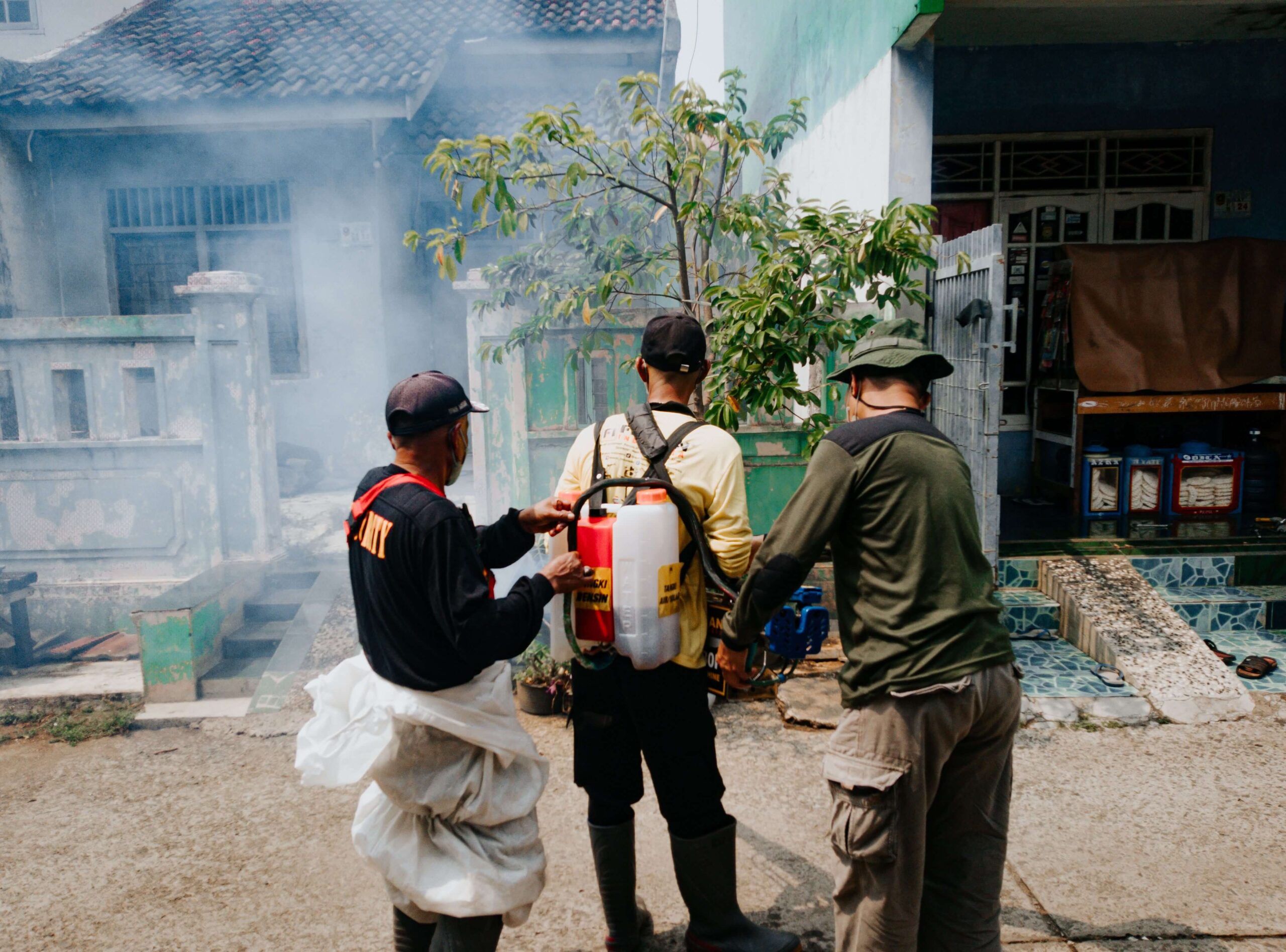 Commercial pest control technicians conducting preventive pest treatment at a business premises in Singapore
